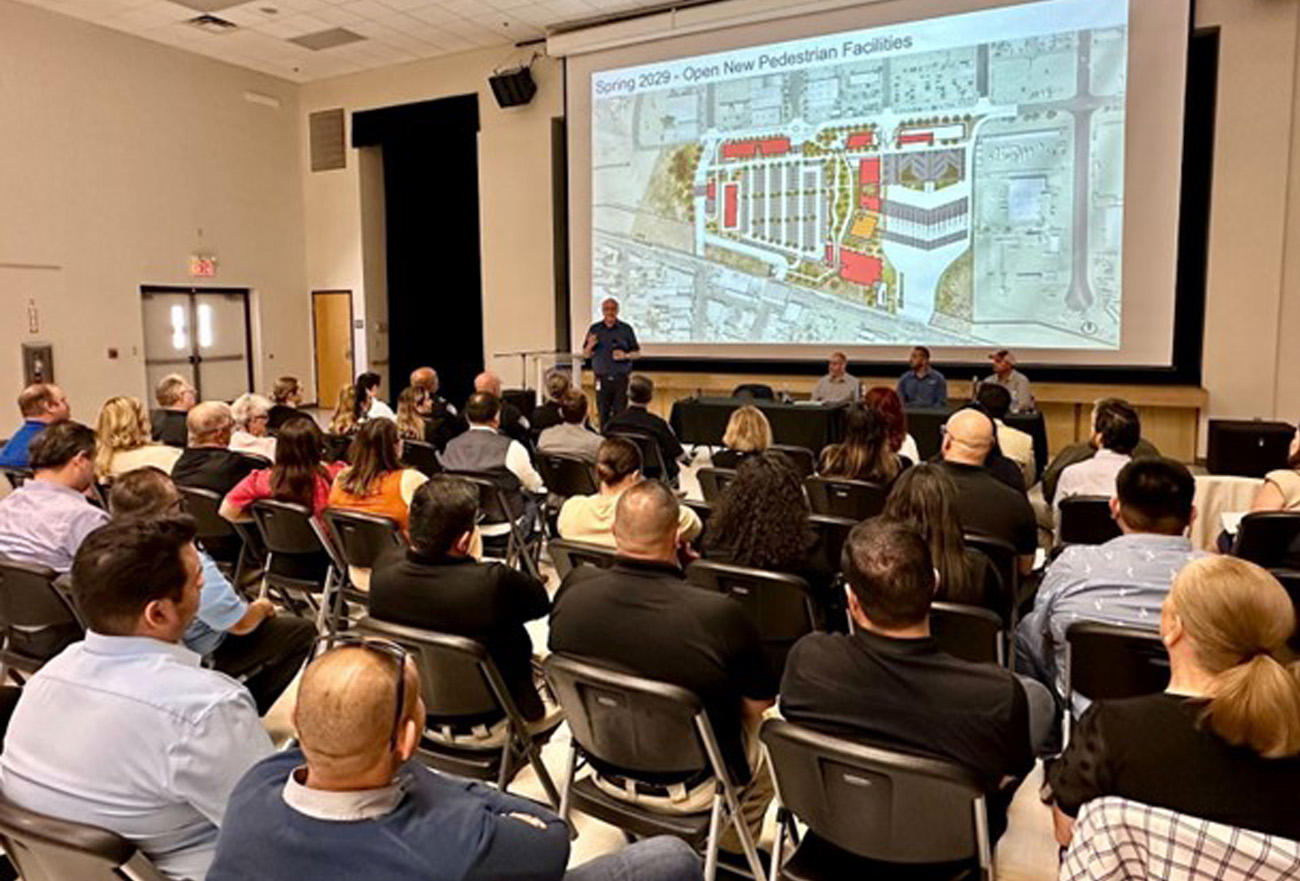 A community event held at Calexico and San Luis. The event photo shows the back of indivdiuals as they are looking at a presentation 