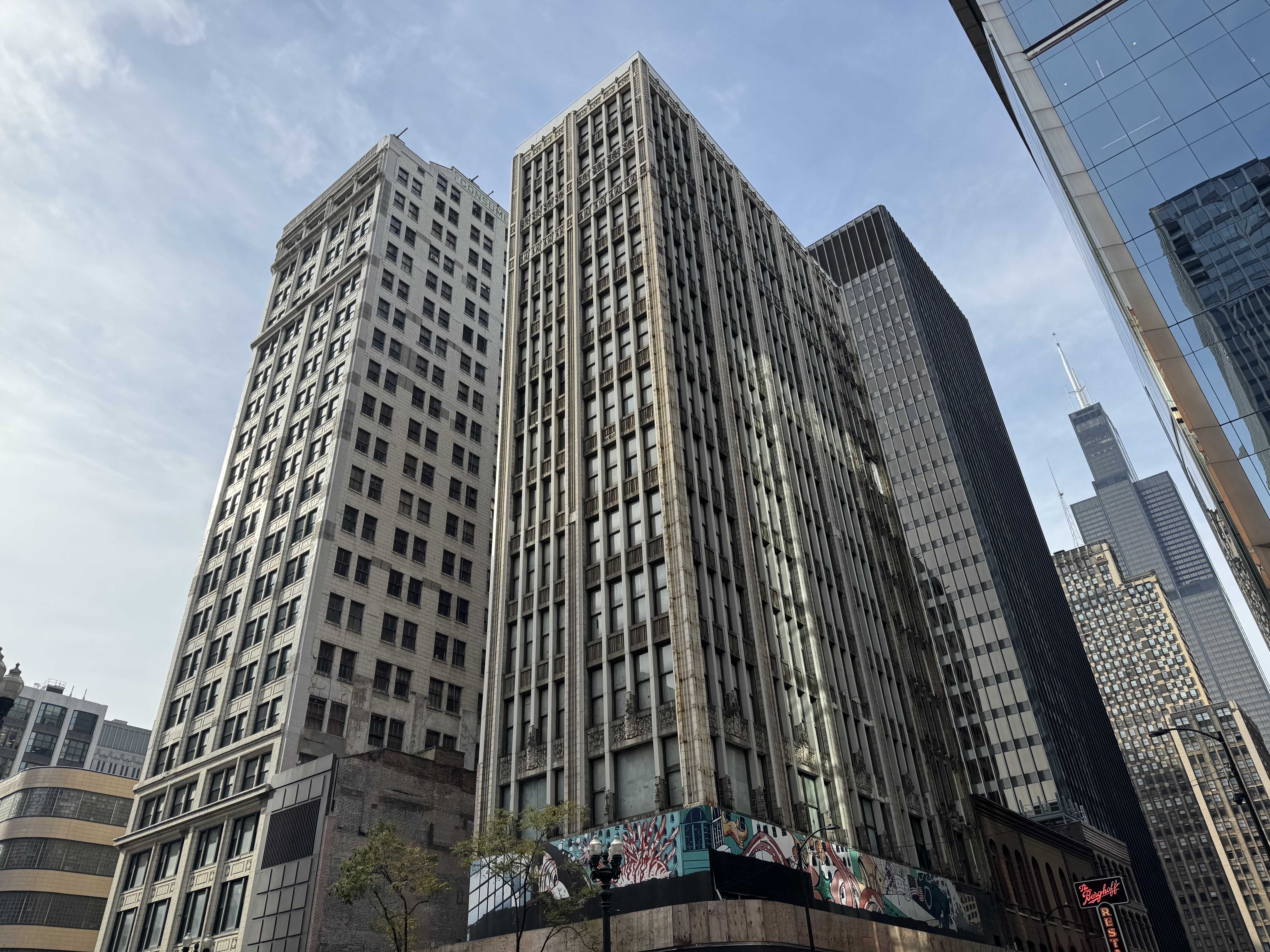 Image of two multi-story brick buildings located at 202 and 220 S. State Street Chicago with other skyscrapers in background..