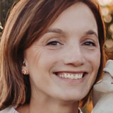 Headshot of Katherine Knecht. Katherine has dark hair and is wearing a white sweater. 