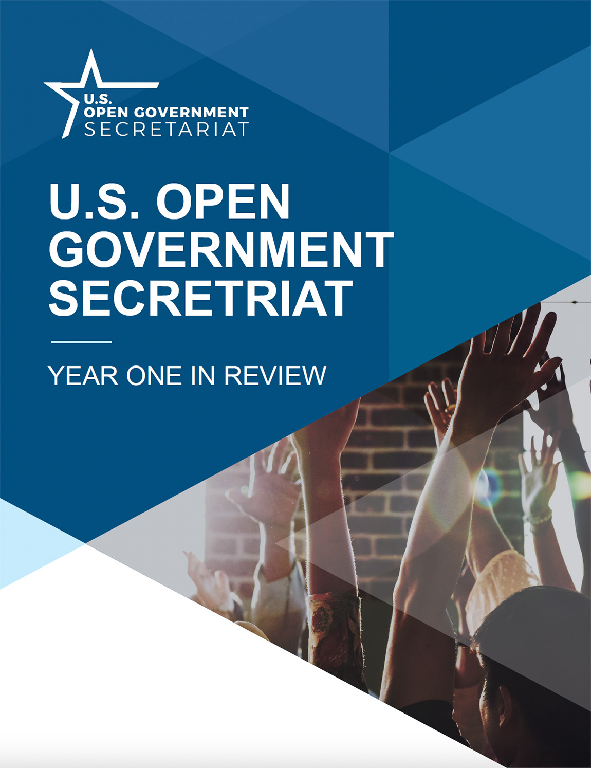 Report cover with text U.S. Open Government Secretariat Year One in Review, and geometric shapes and a photo of hands