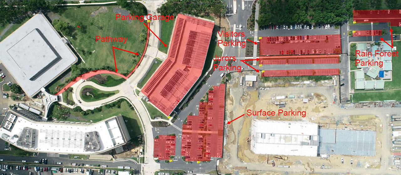 Aerial view of a lot of buildings and parking lots and green areas, with some designations overlaying it