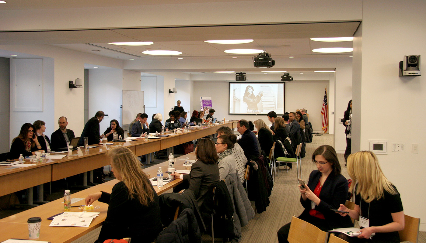 Participants sitting at long table in room