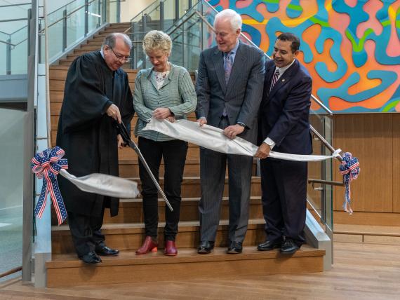 Ribbon Cutting on stairs inside building