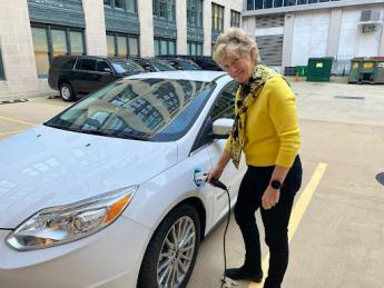 Robin Carnahan charges an electric vehicle