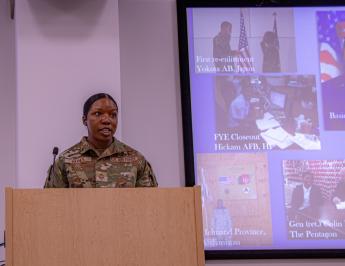 Chief Master Sergeant Sharma Haynes delivers remarks from the podium.