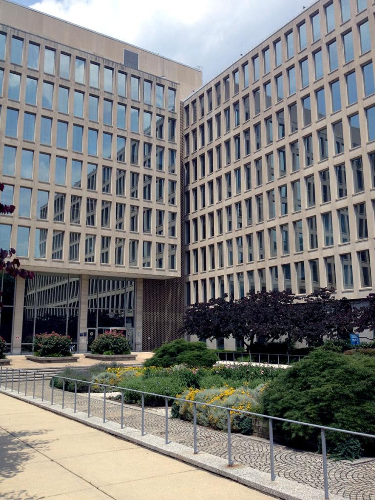 Brutalist style multi-story rectangular building with all windows the same size