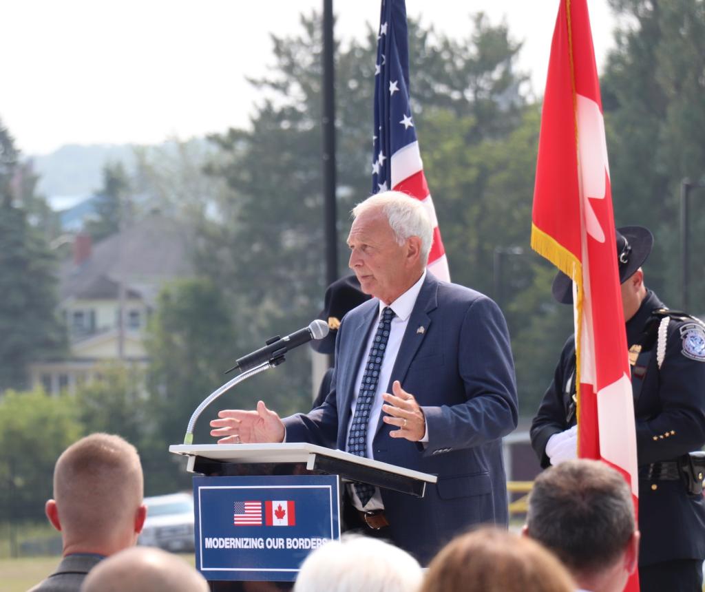 A man in a suit stands at the podium