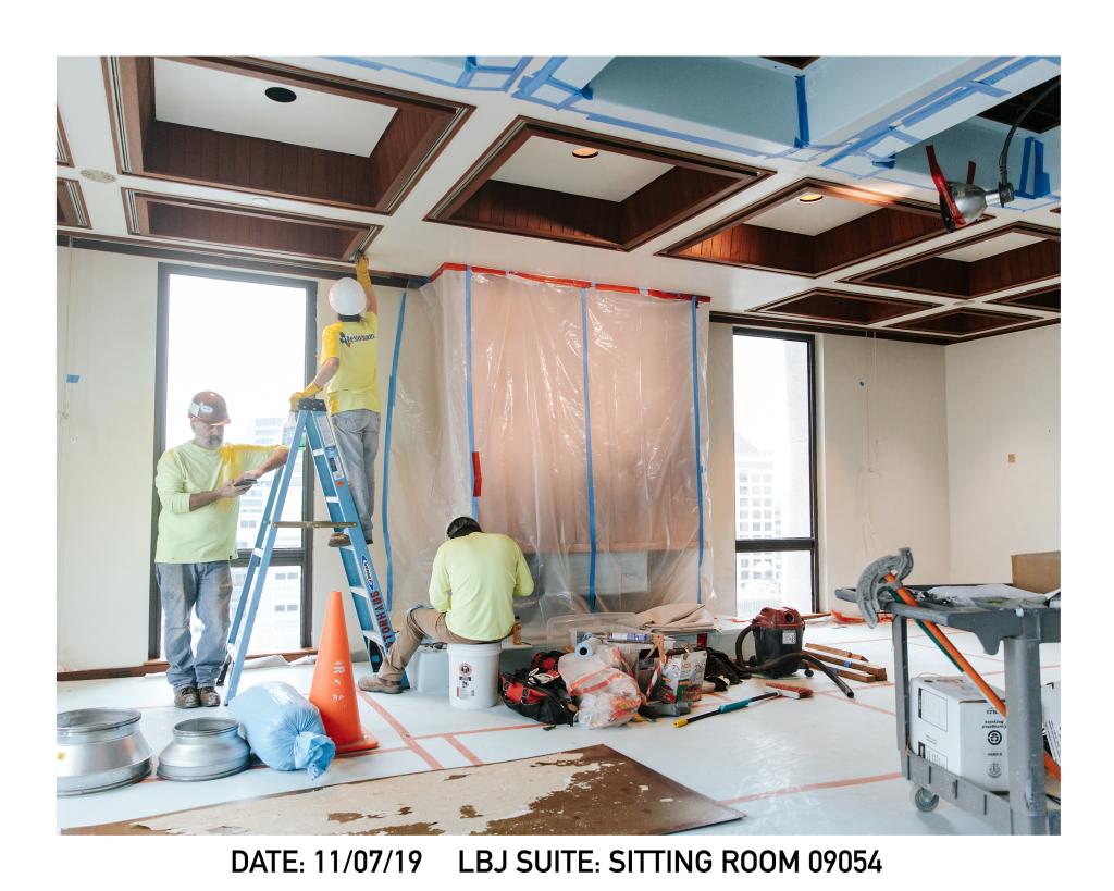 Construction workers work in LBJ Suite sitting room