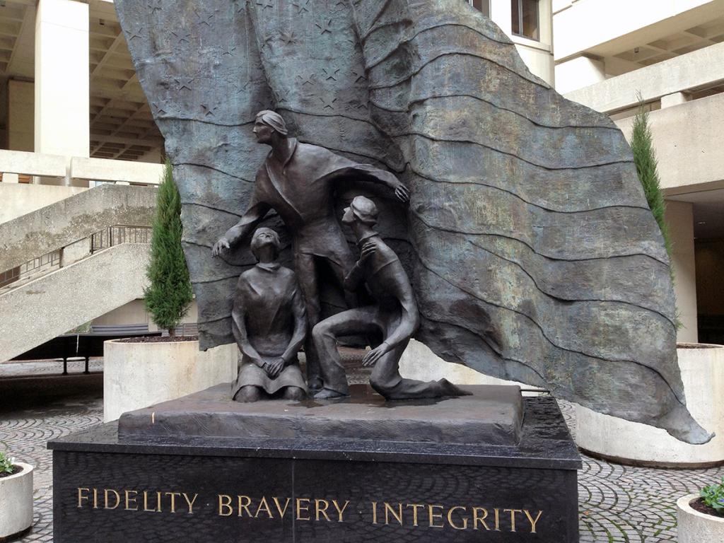 Bronze sculpture of three figures with flag entitled Fidelity, Bravery, Integrity